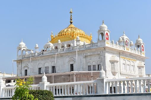 a white building with gold roof